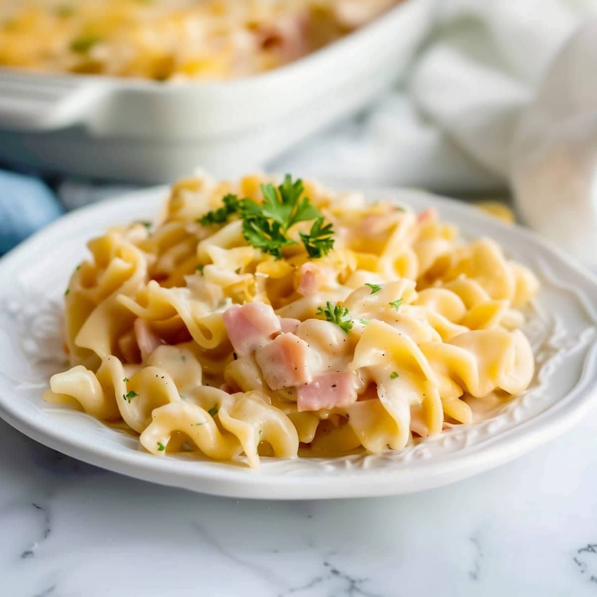 Cheesy ham and egg noodles in an elegant plate.