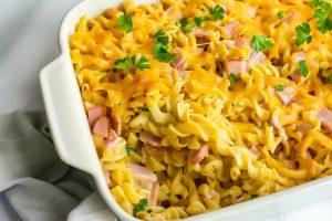 Overhead view of cheesy and hearty homemade ham and noodle casserole.