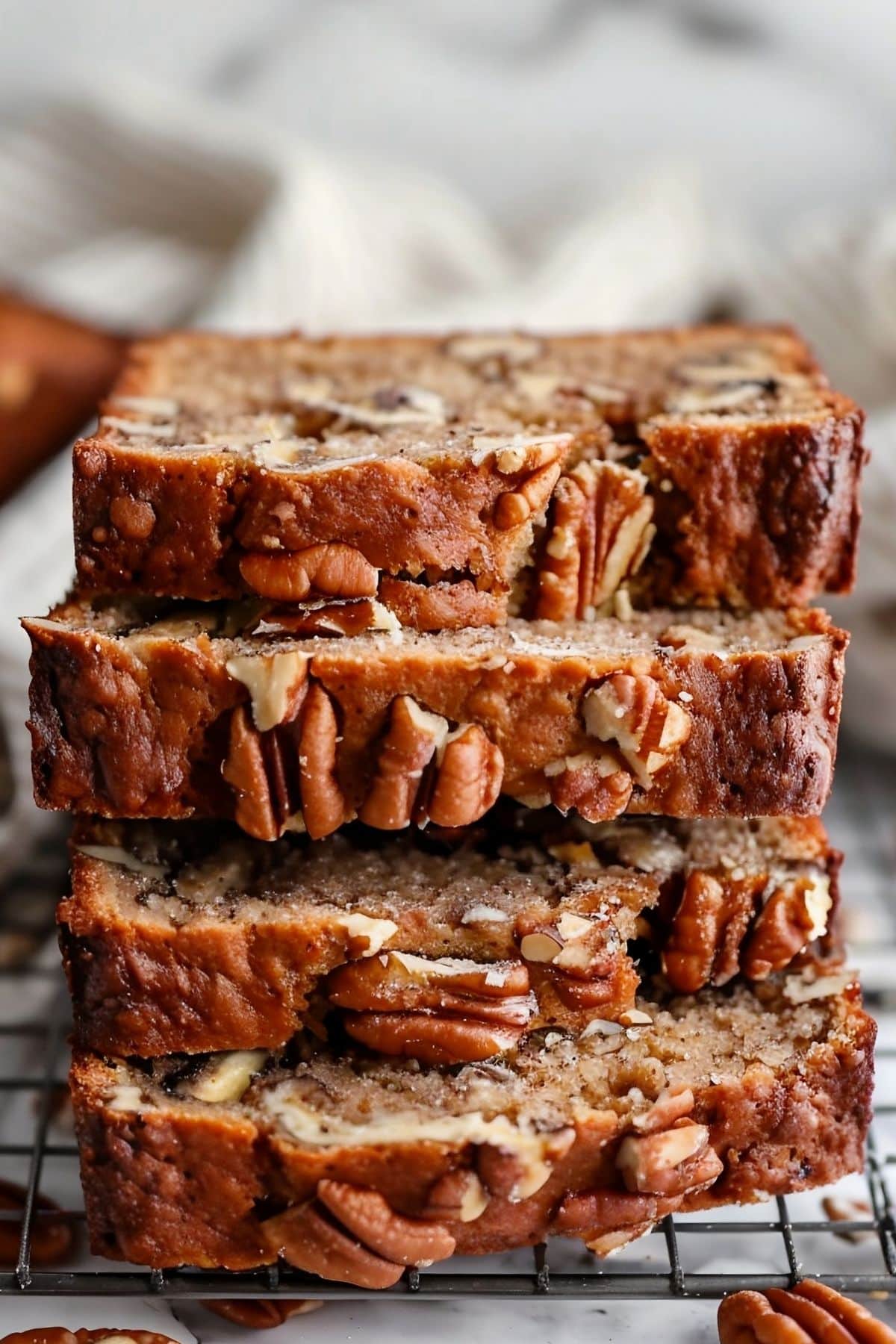 Close Up of Slices of Ina Garten's Banana Bread with Pecans, Stacked on a Wire Rack