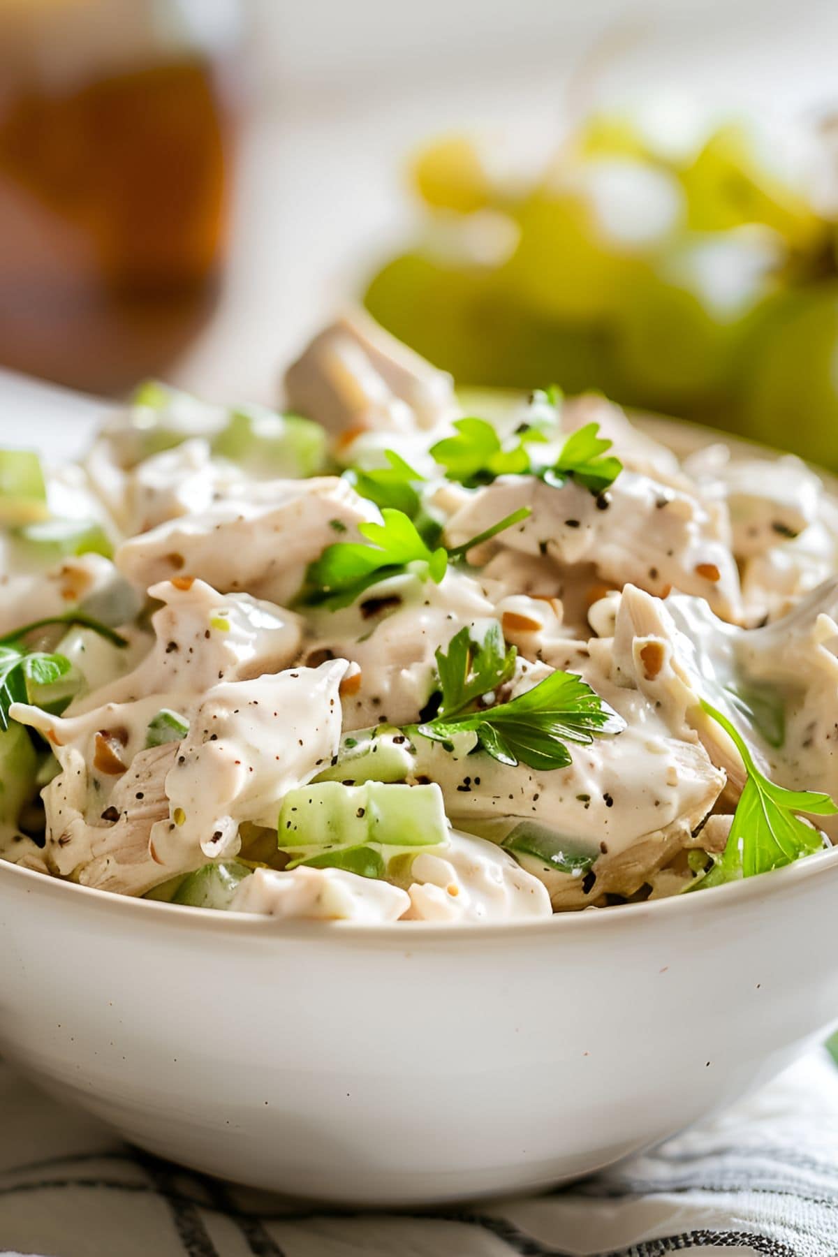 Super Close Up of Ina Garten's Chicken Salad in a Bowl with Herbs, Seasonings, and Lots of Sauce