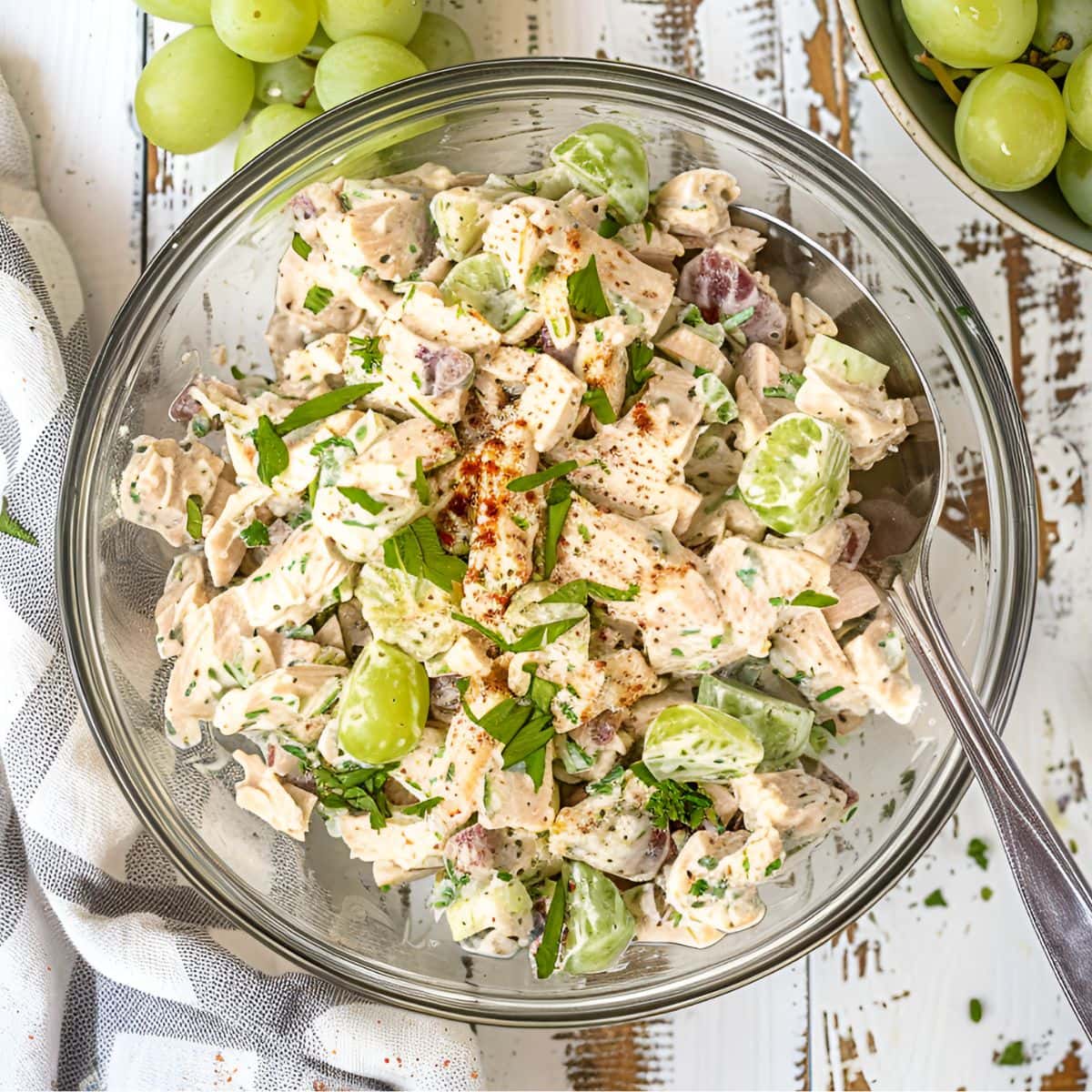 Top View of Ina Garten's Chicken Salad in a Glass bowl with Herbs and Seasonings