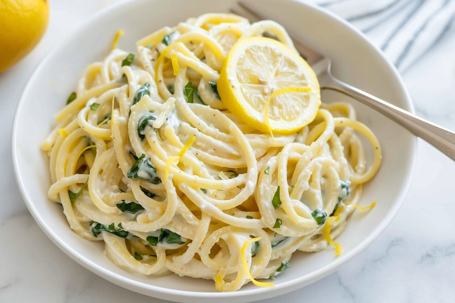 Citrusy and delicious lemon ricotta pasta with fork in a bowl ready to serve.