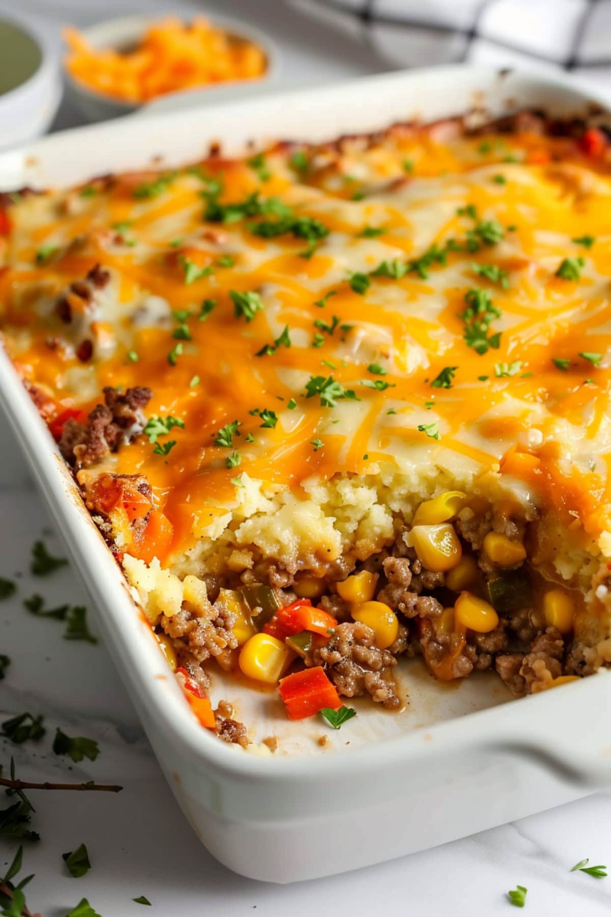 Portion missing Mexican cornbread casserole in a rectangular baking dish. 