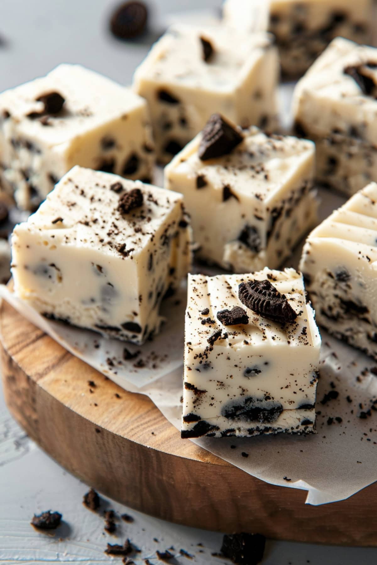 Bunch of cube sliced Oreo fudge in a wooden board with parchment paper.