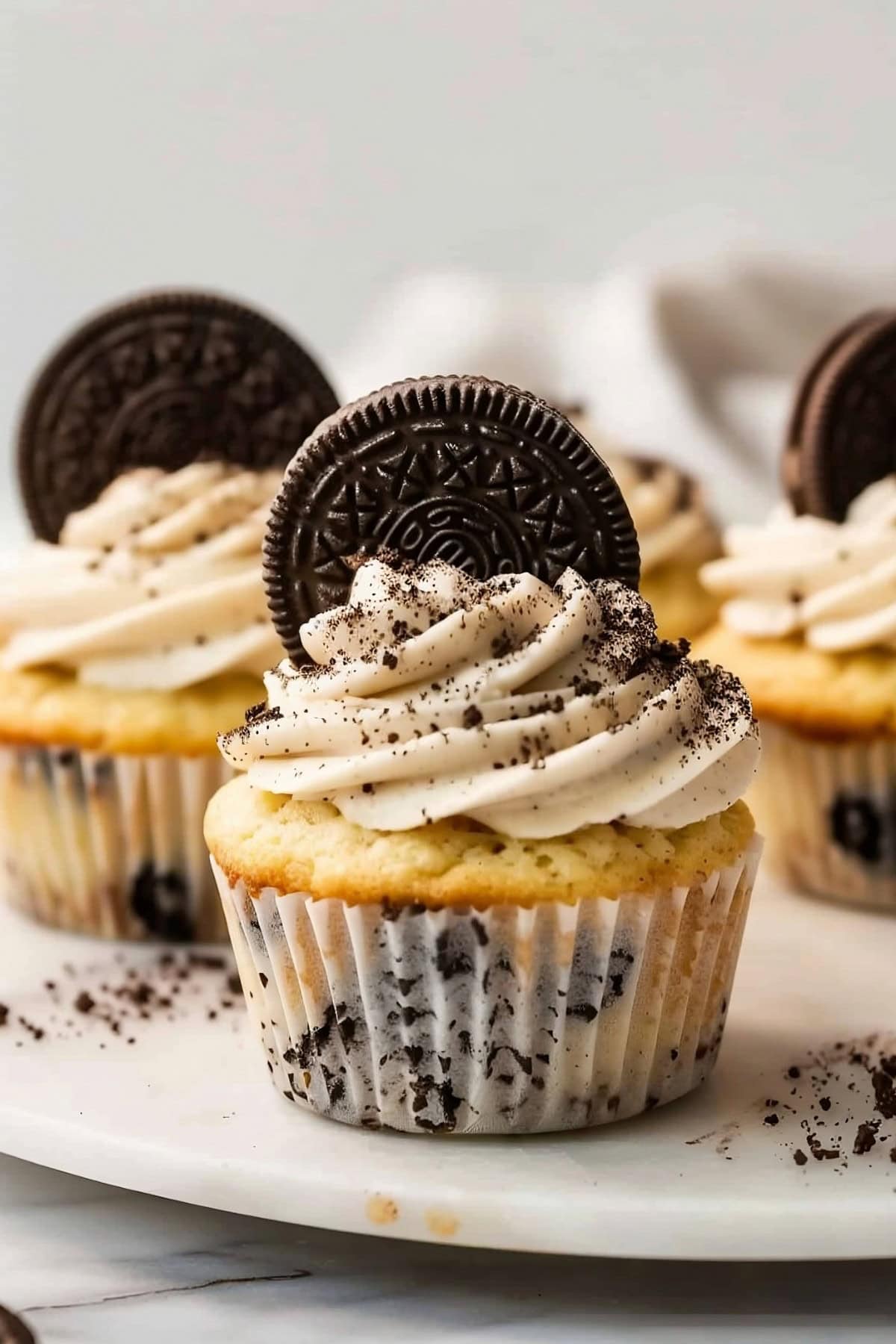 Irresistible homemade Oreo cupcakes, adorned with a generous rosette of frosting and a whole Oreo cookie.