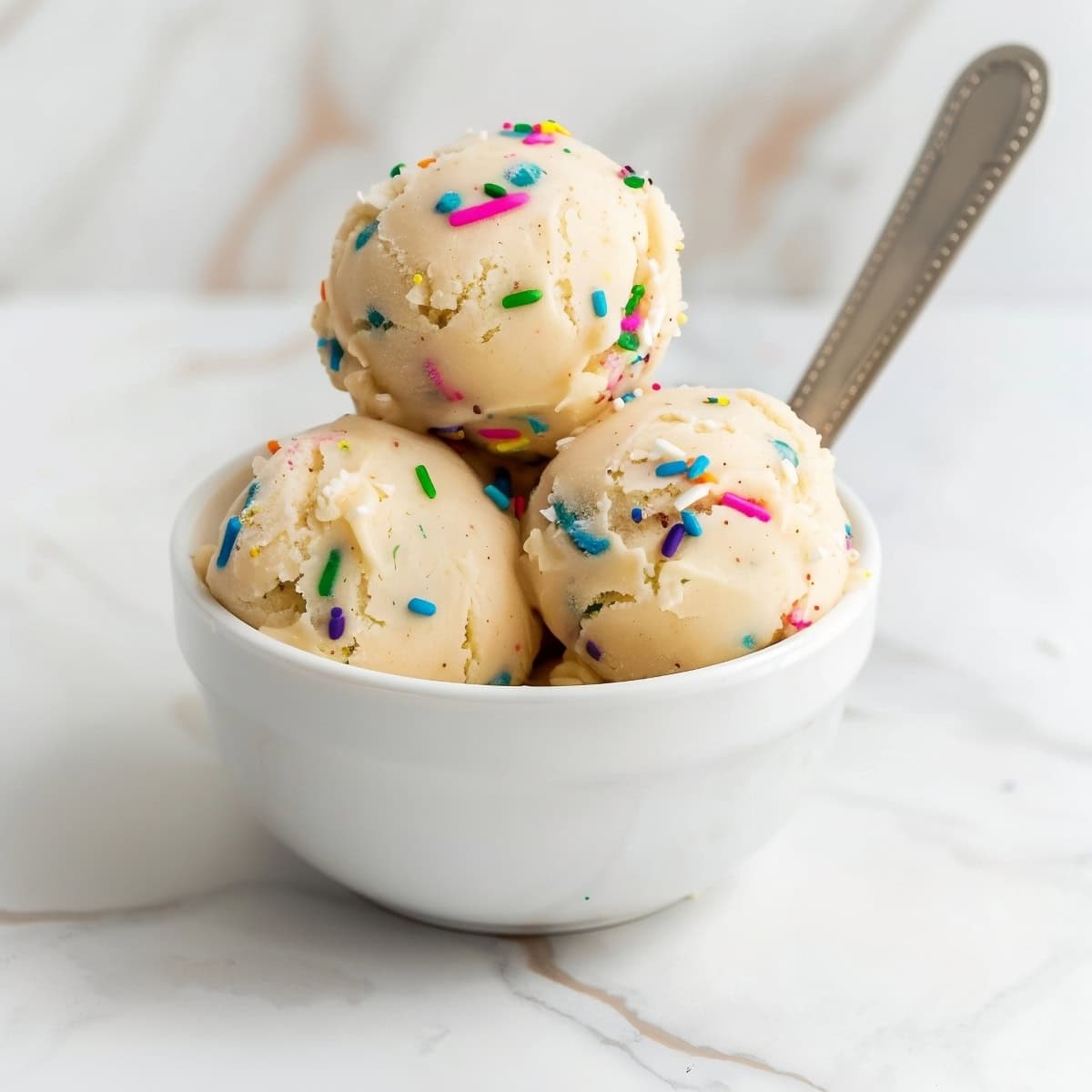 Homemade edible sugar cookie dough, featuring a rich, creamy consistency and colorful confetti sprinkles.