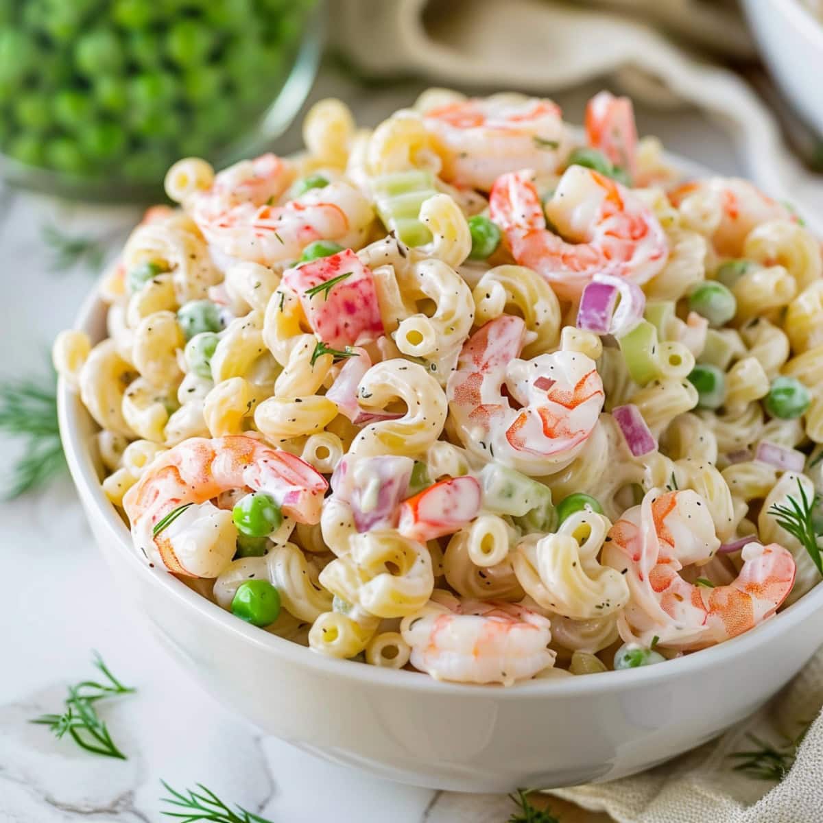 Shrimp pasta salad with mix of shrimps, green peas, pasta in creamy white dressing.