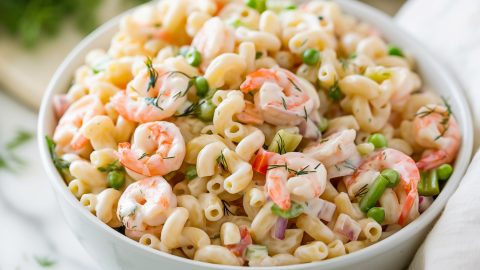 Shrimp pasta salad in a large white bowl.