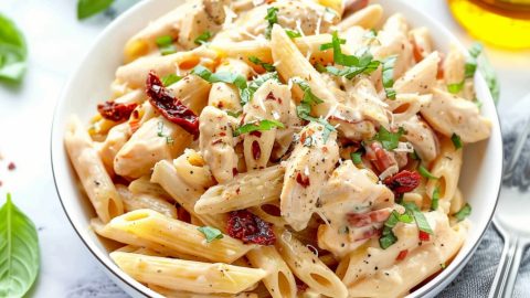 Pasta with sun-dried tomatoes with creamy sauce on a plate.