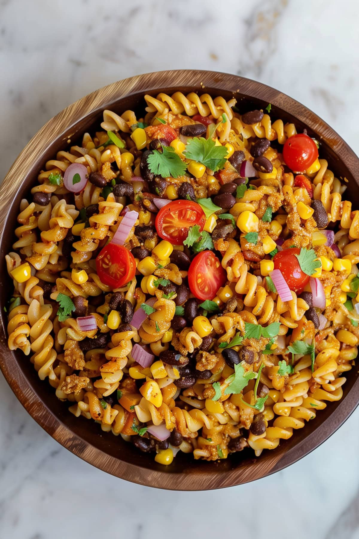 Colorful taco pasta salad, featuring rotini pasta, ground beef, and a medley of vegetables.
