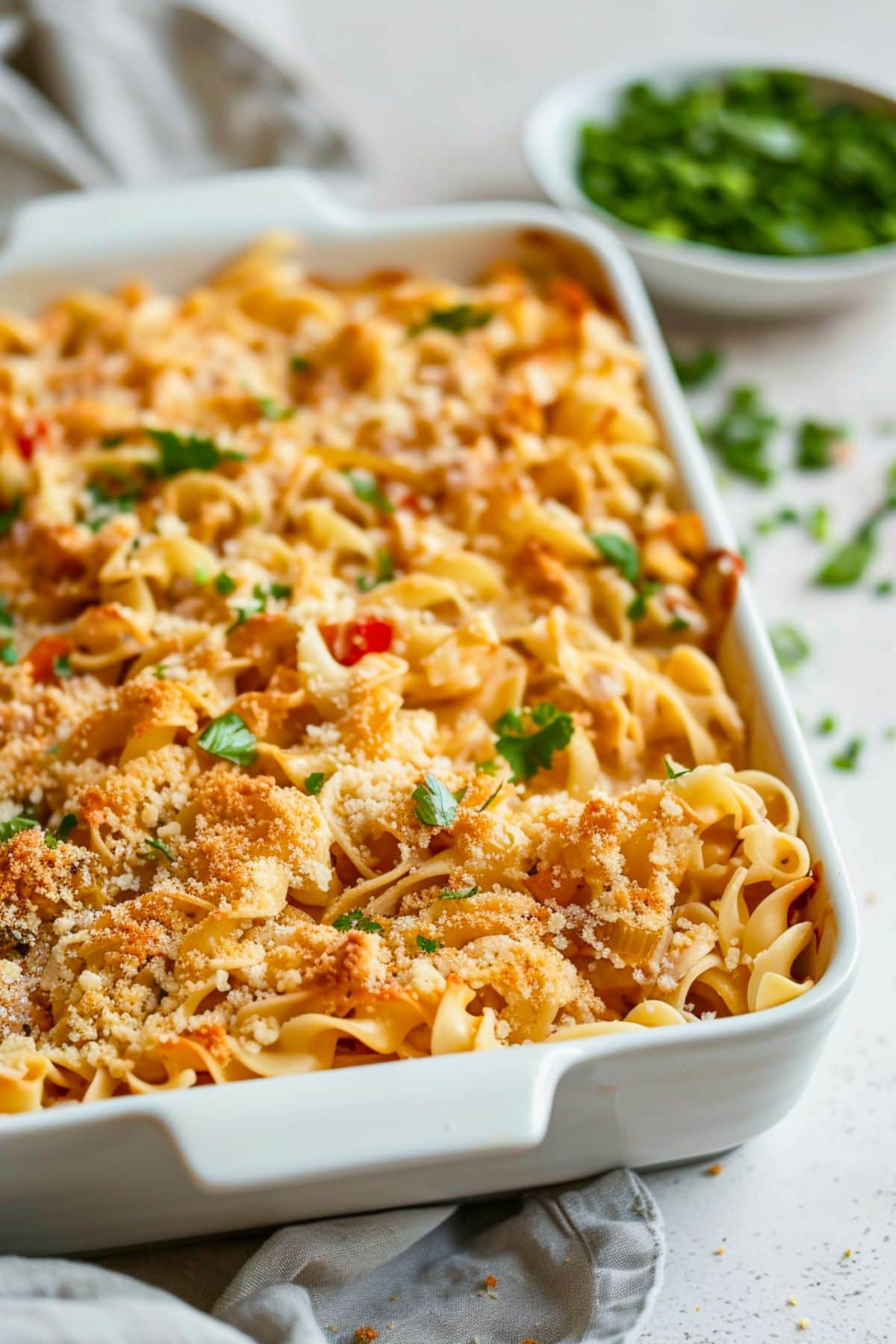 Turkey noodle casserole in a baking dish covered with bread crumbs.