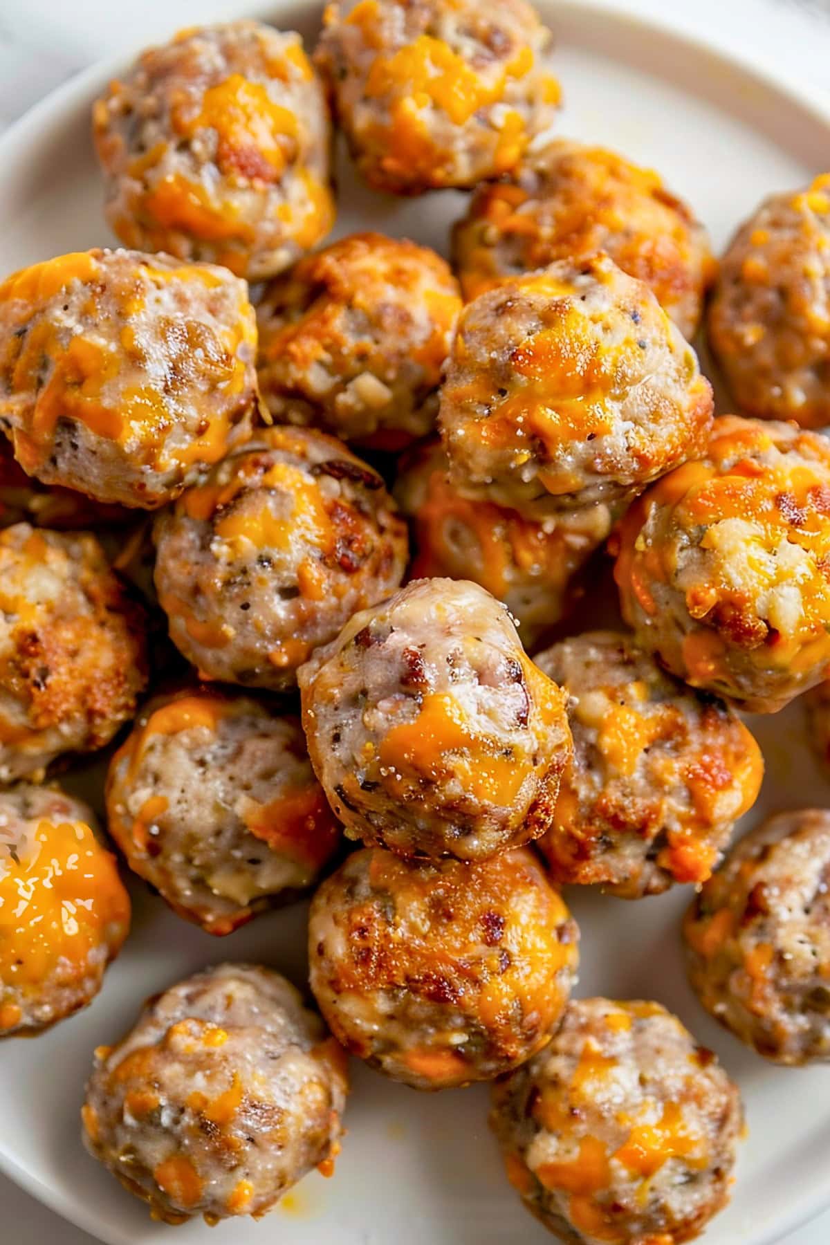 Top View of Cheesy, Golden Cream Cheese Sausage Balls on a Plate