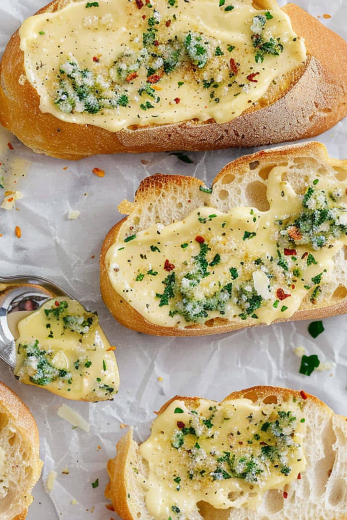 Sliced baguette with butter garlic spread on top. 