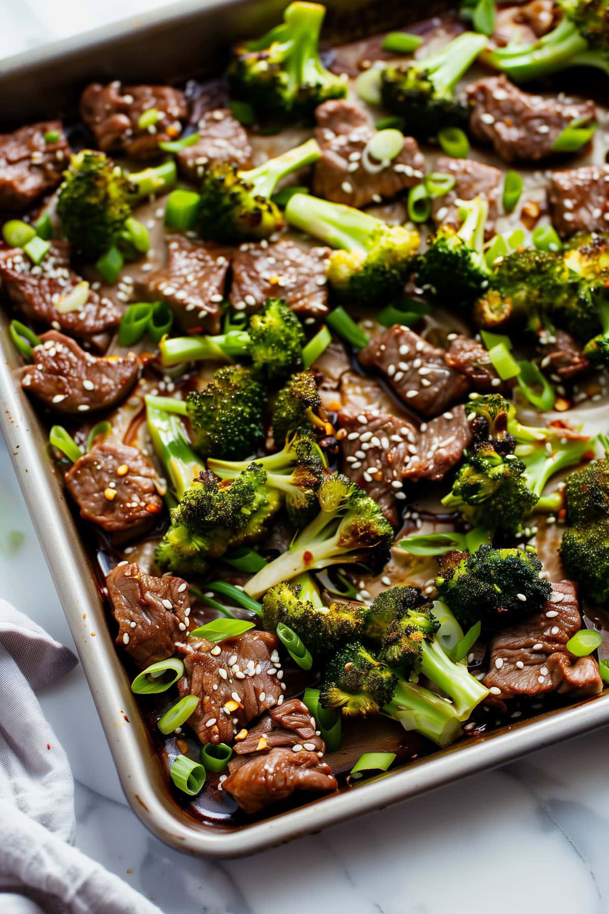 Delicious sheet pan beef and broccoli, featuring a savory sauce and perfectly roasted vegetables.