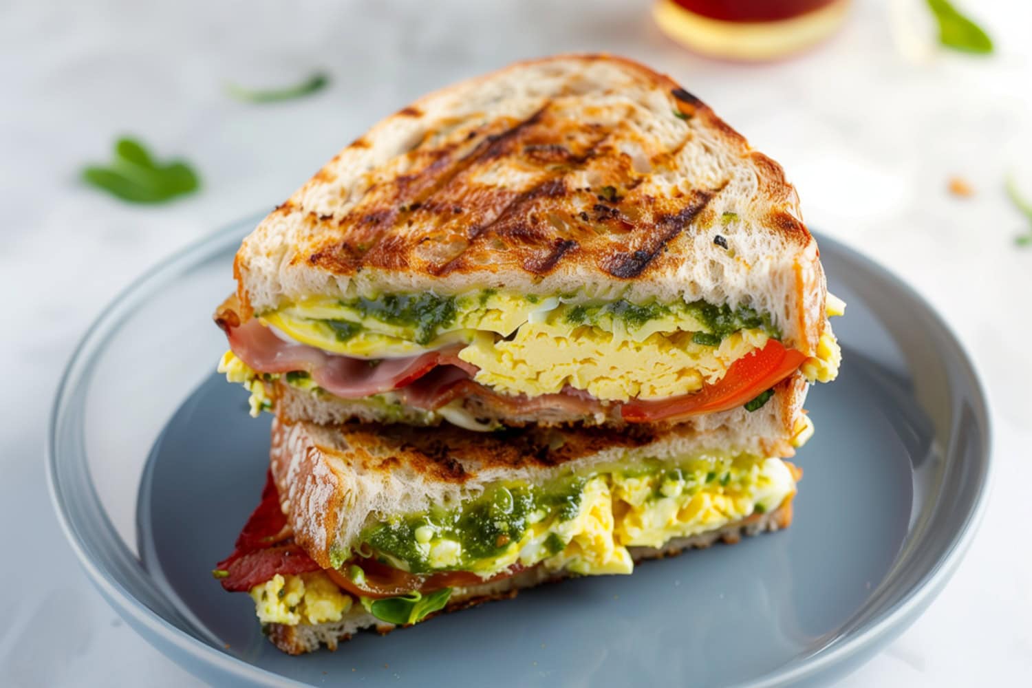 Warm Breakfast Panini Filled With Eggs, Tomatoes, Crispy Bacon and Spinach.