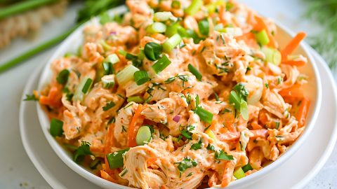 Buffalo chicken salad served on a white bowl.