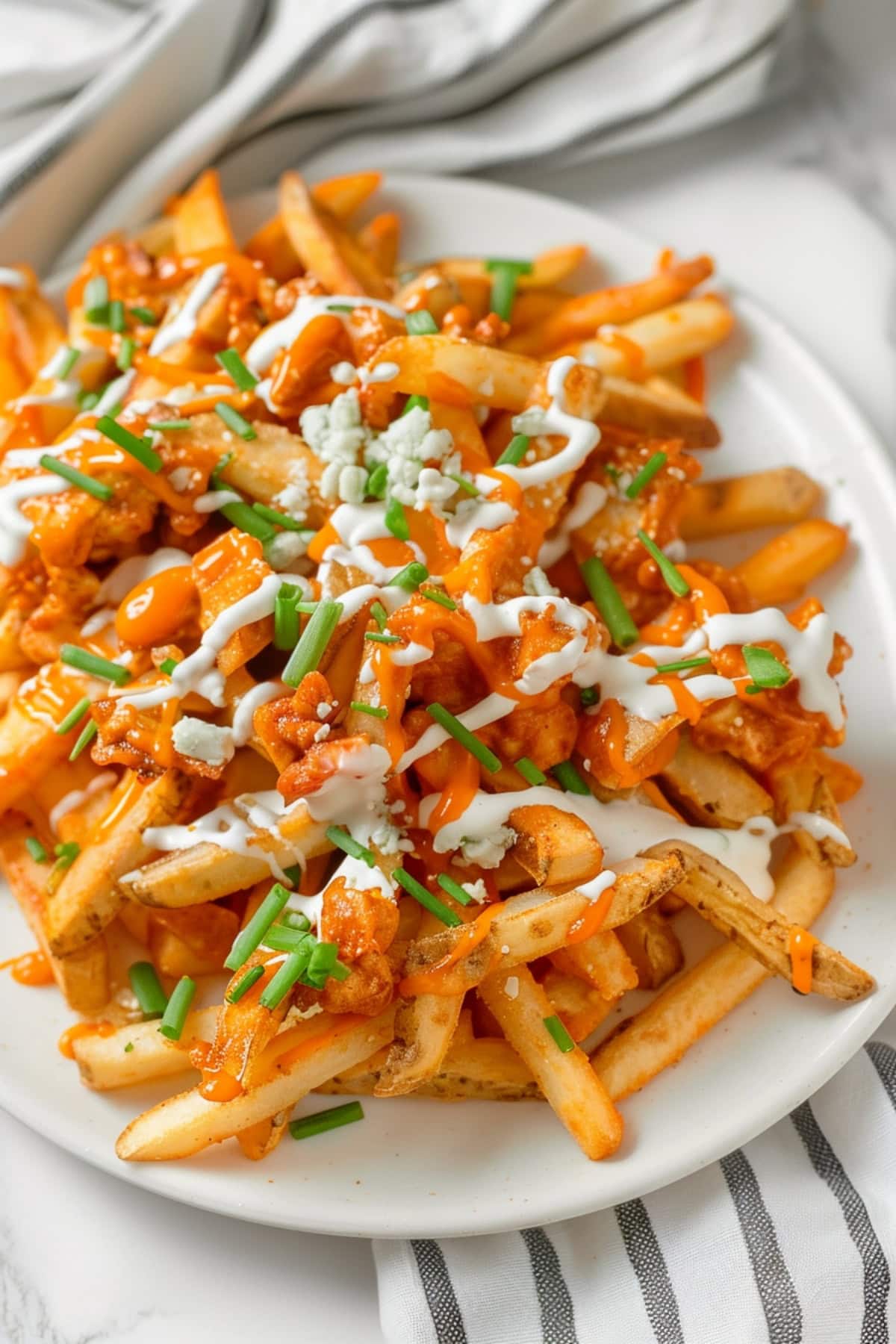 Homemade fries with buffalo sauce, crumbled blue cheese and chopped green chives.