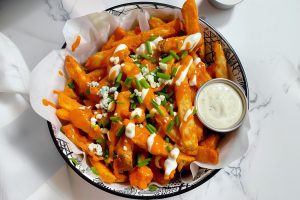 Saucy homemade buffalo fries with a creamy dip.