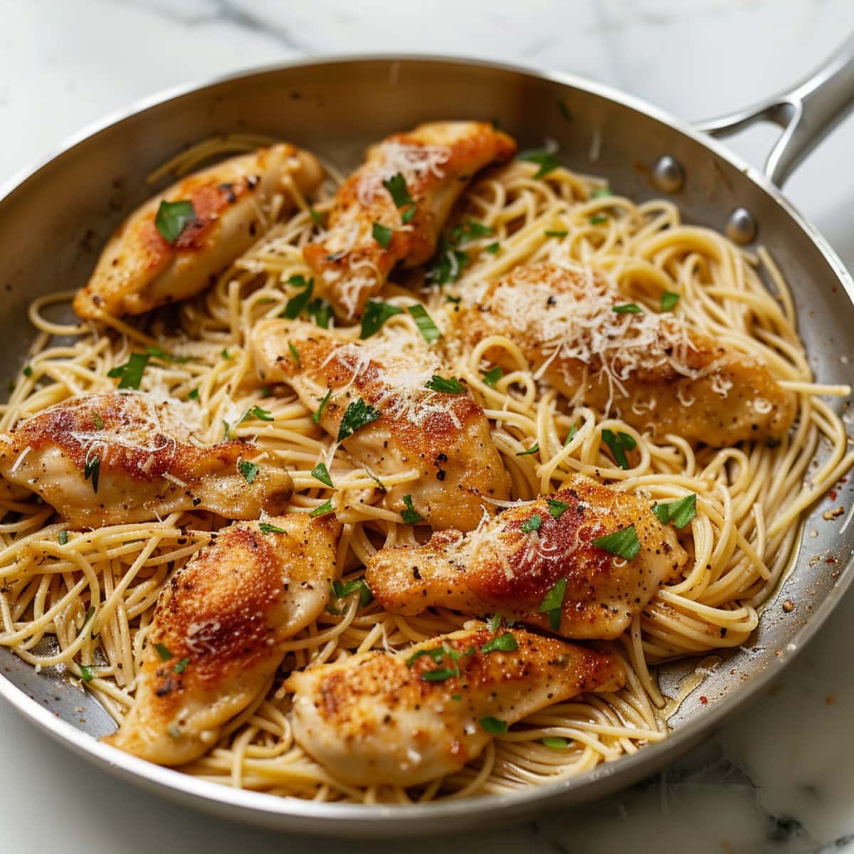 Chicken scampi tossed in a large skillet.
