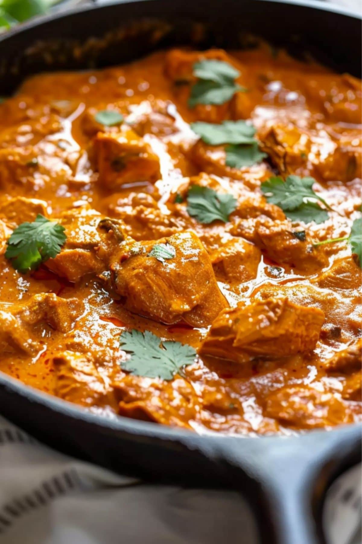 Chicken tikka masala in a cast iron skillet, close up.