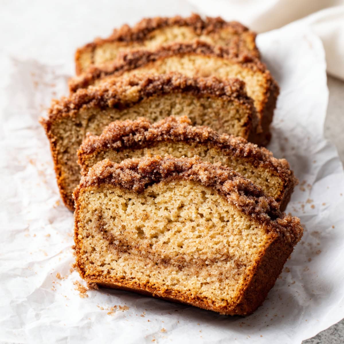 Cinnamon crunch banana bread on a white parchment paper.