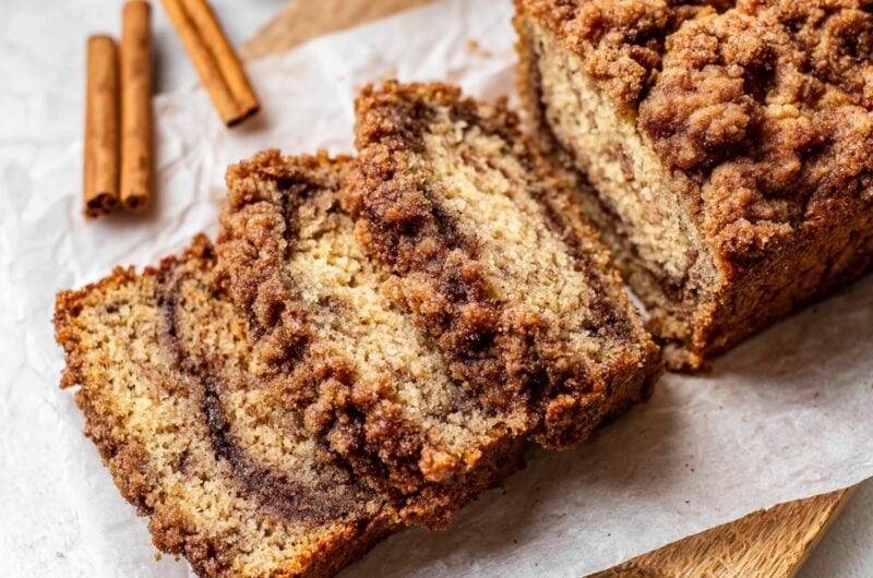 Overhead view of cinnamon crunch banana bread in a wooden board with parchment paper.