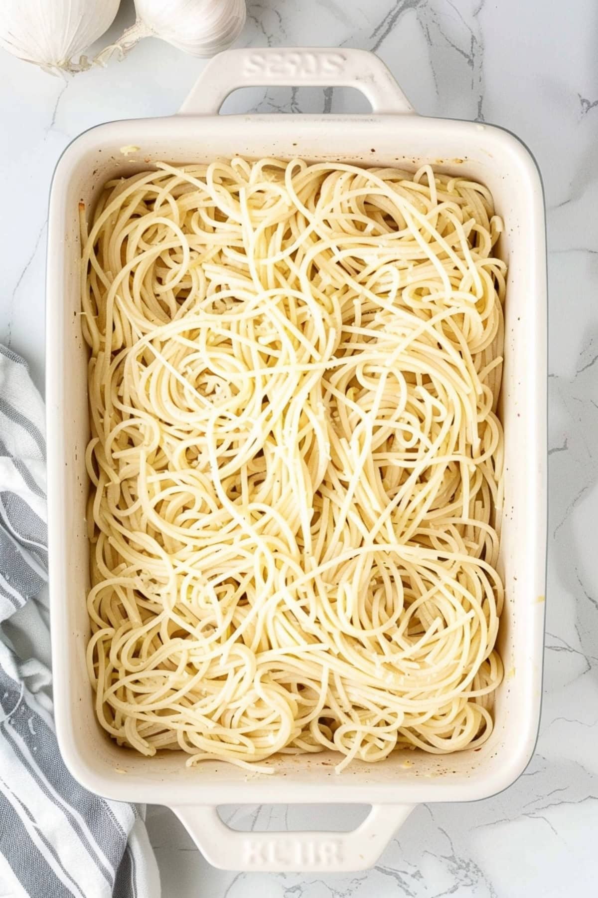 Overhead view of cooked pasta in a white baking dish.