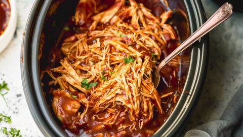 Shredded chicken in bbq sauce inside slow cooker.