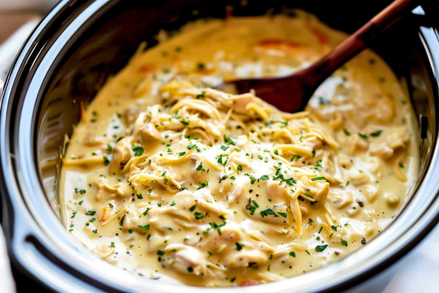 Crockpot Italian chicken made with shredded chicken in white creamy sauce.