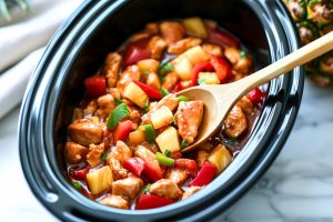 Sweet and sour chicken cooked inside a slow cooker.