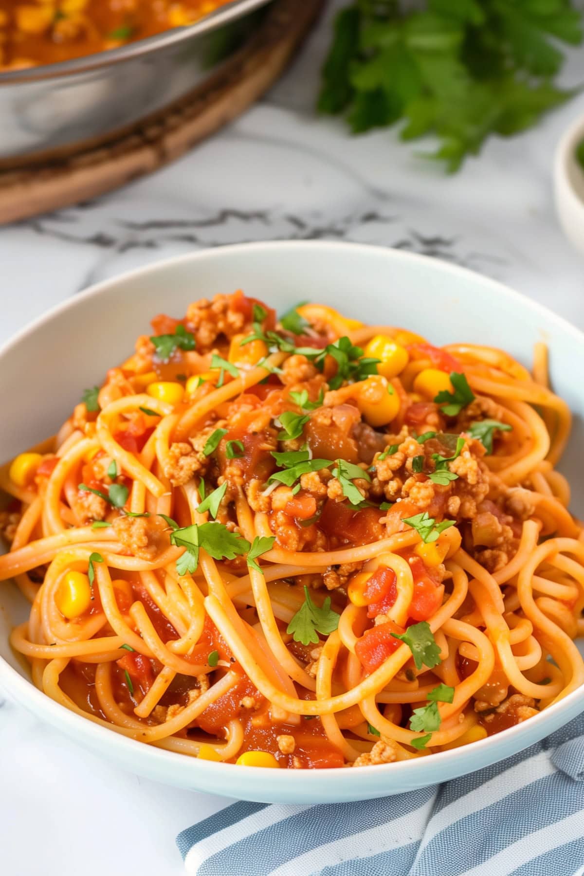 Flavorful Mexican spaghetti, featuring a zesty tomato sauce in a white plate.