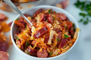 Sauteed cabbage and sausage in a bowl.