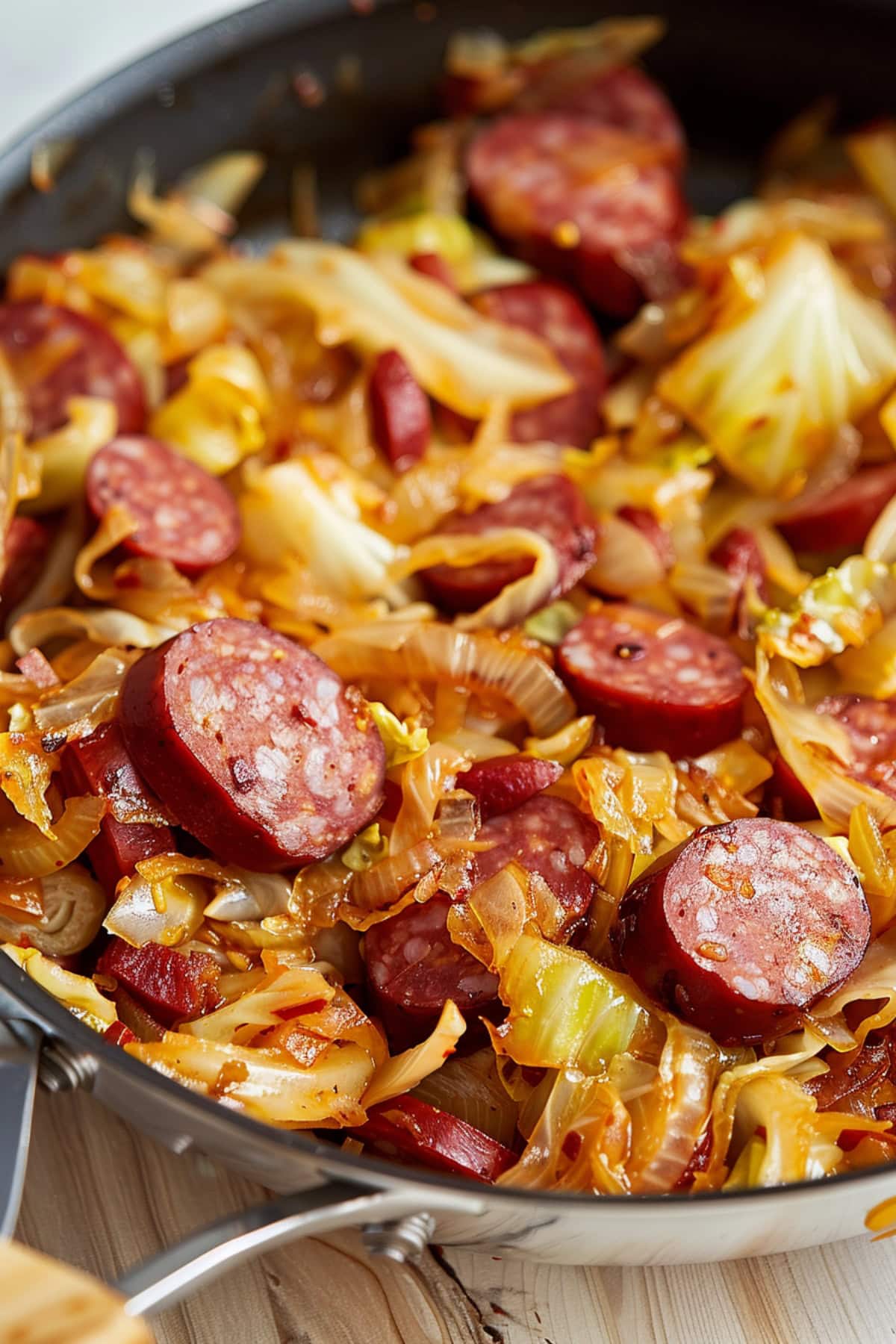 Sausage and cabbage sauteed in an iron skillet.