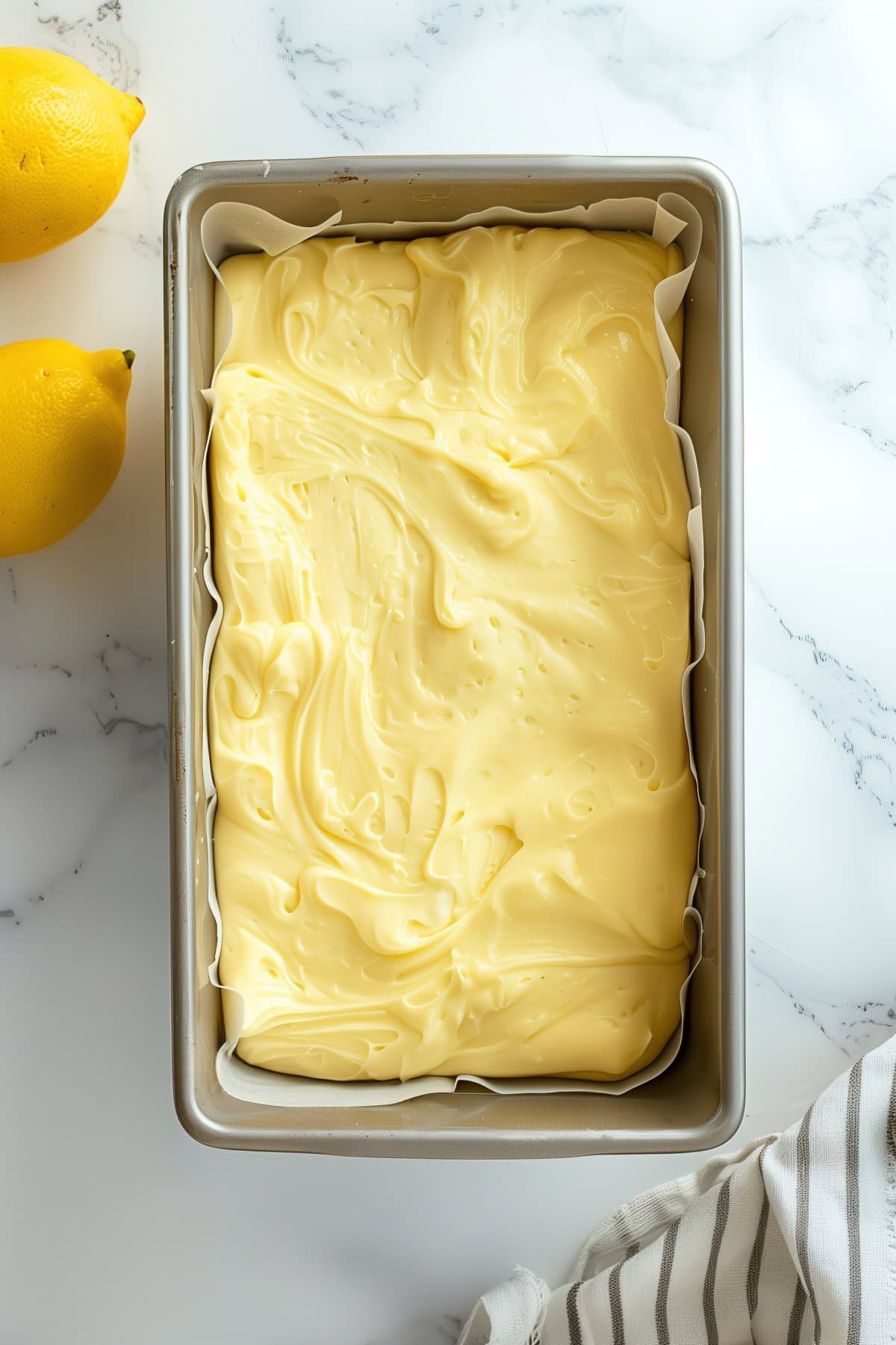 A baking pan filled with lemon cake batter, top down view