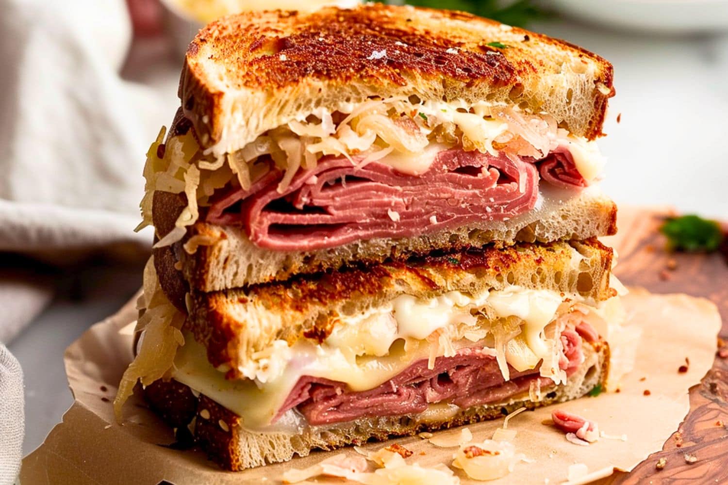 Cheesy pastrami sandwich in a wooden board.