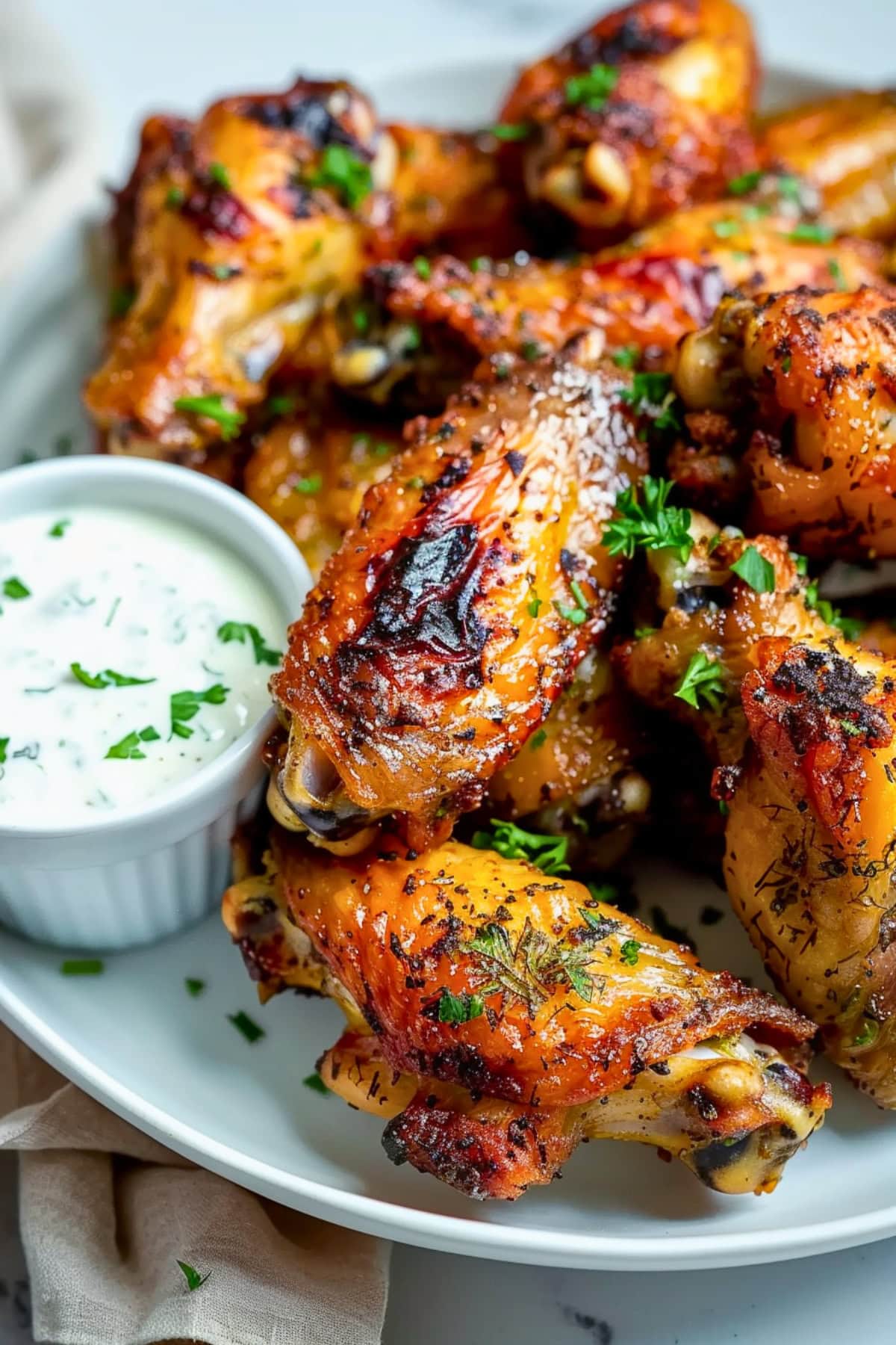 Crispy baked ranch chicken wings on plate with ranch dressing