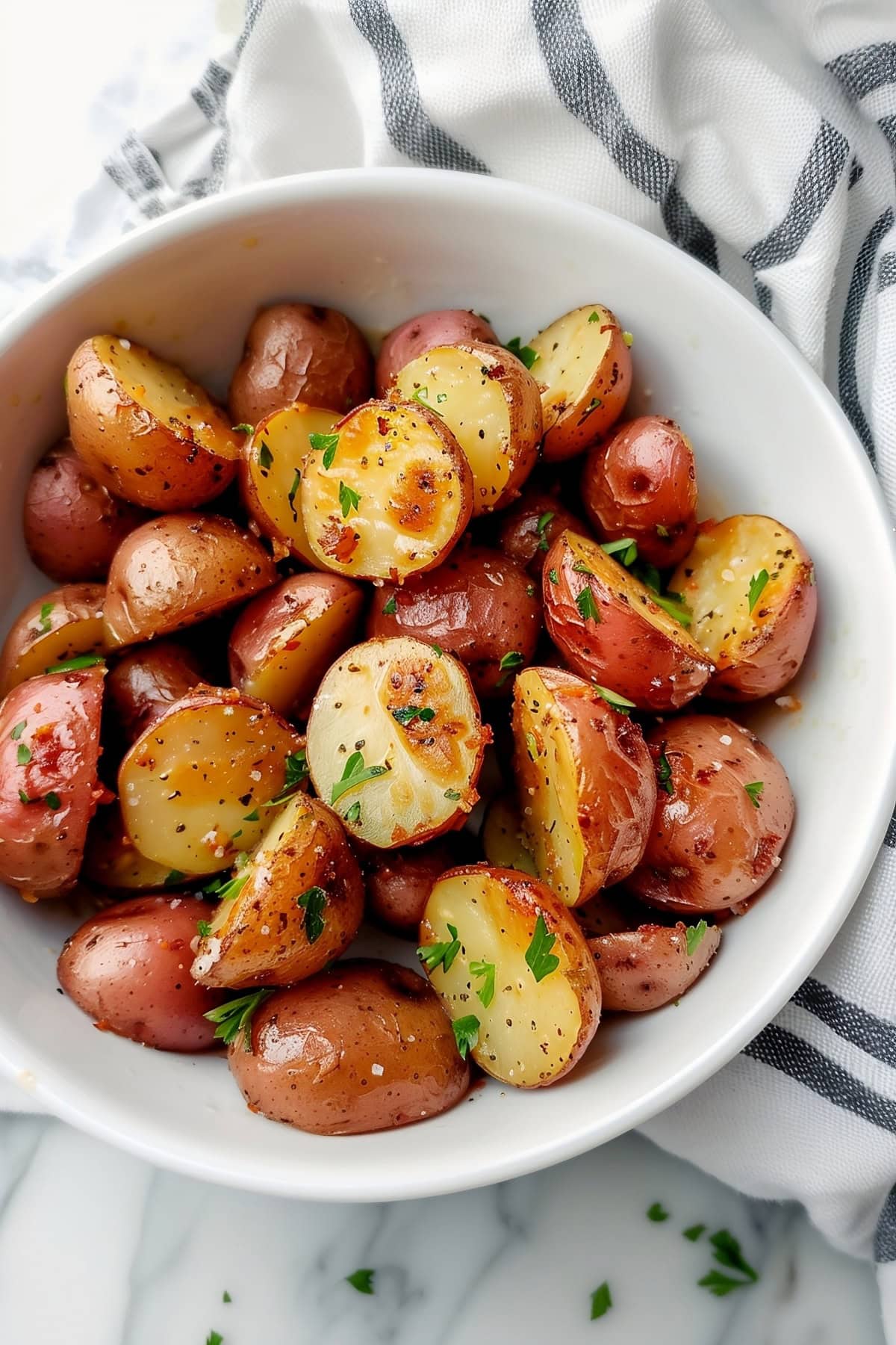 Homemade ranch roasted potatoes, garnished with herbs.