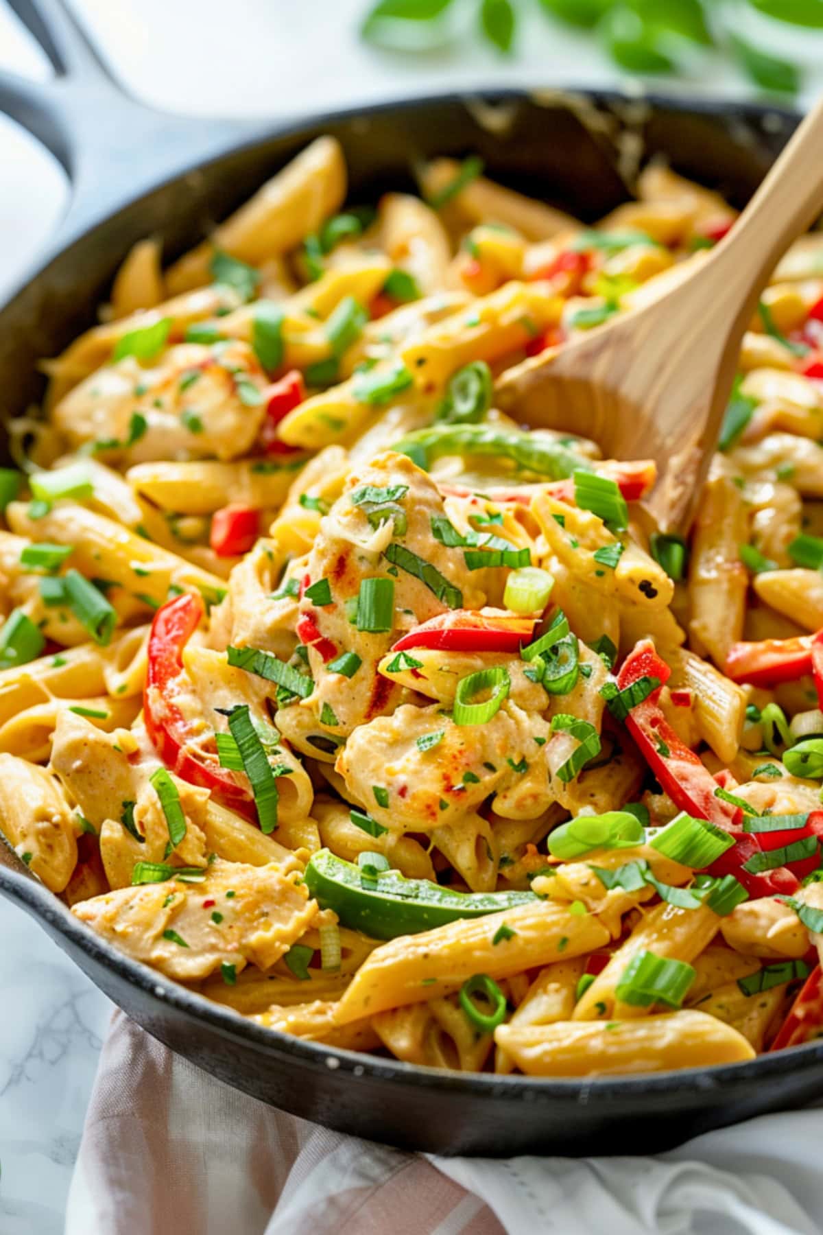 Tender jerk-seasoned chicken, perfectly cooked penne, and a medley of bell peppers tossed in a creamy, cheesy sauce.