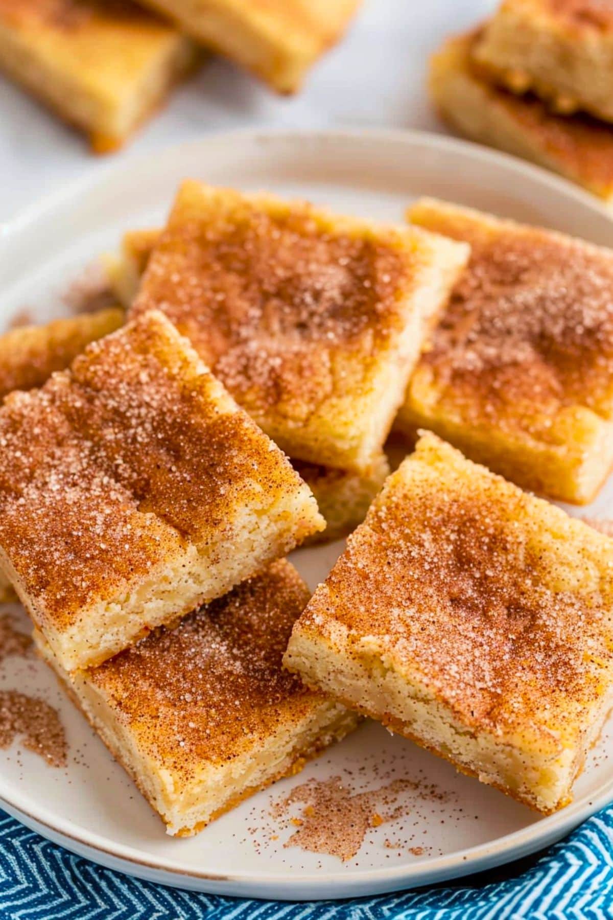 Snickerdoodle bars arranged on a white plate. 