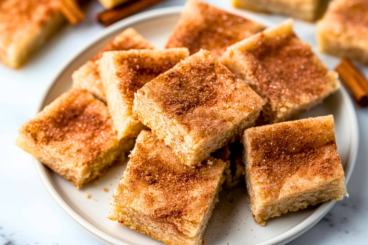 Snickerdoodle bars arranged in a white plate.