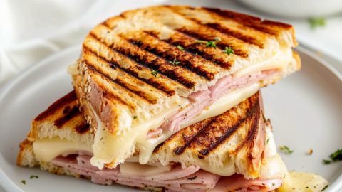 Panini press with Swiss cheese, tender ham, softened butter and tangy mustard.