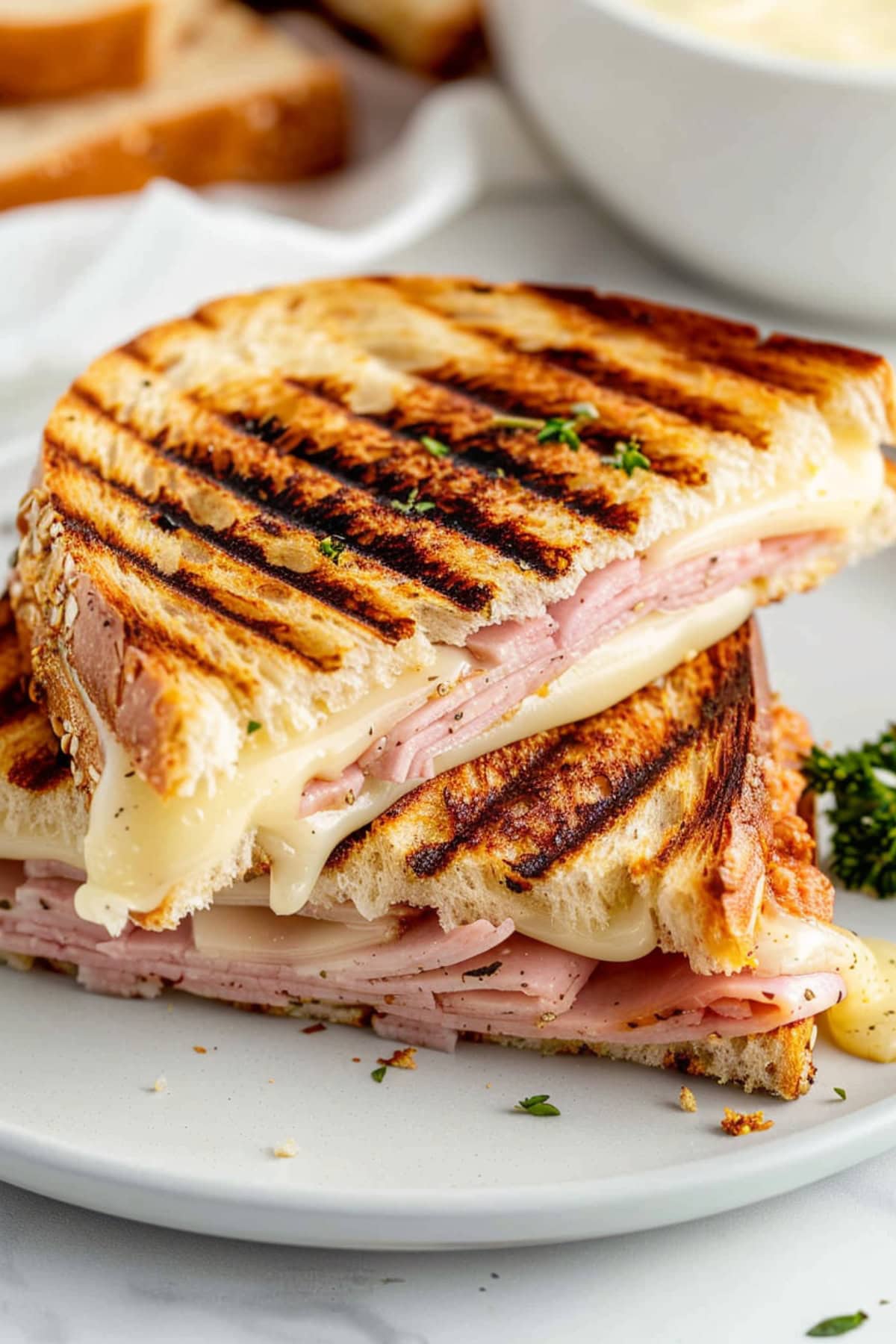 Grilled panini sandwich with ham and cheese.