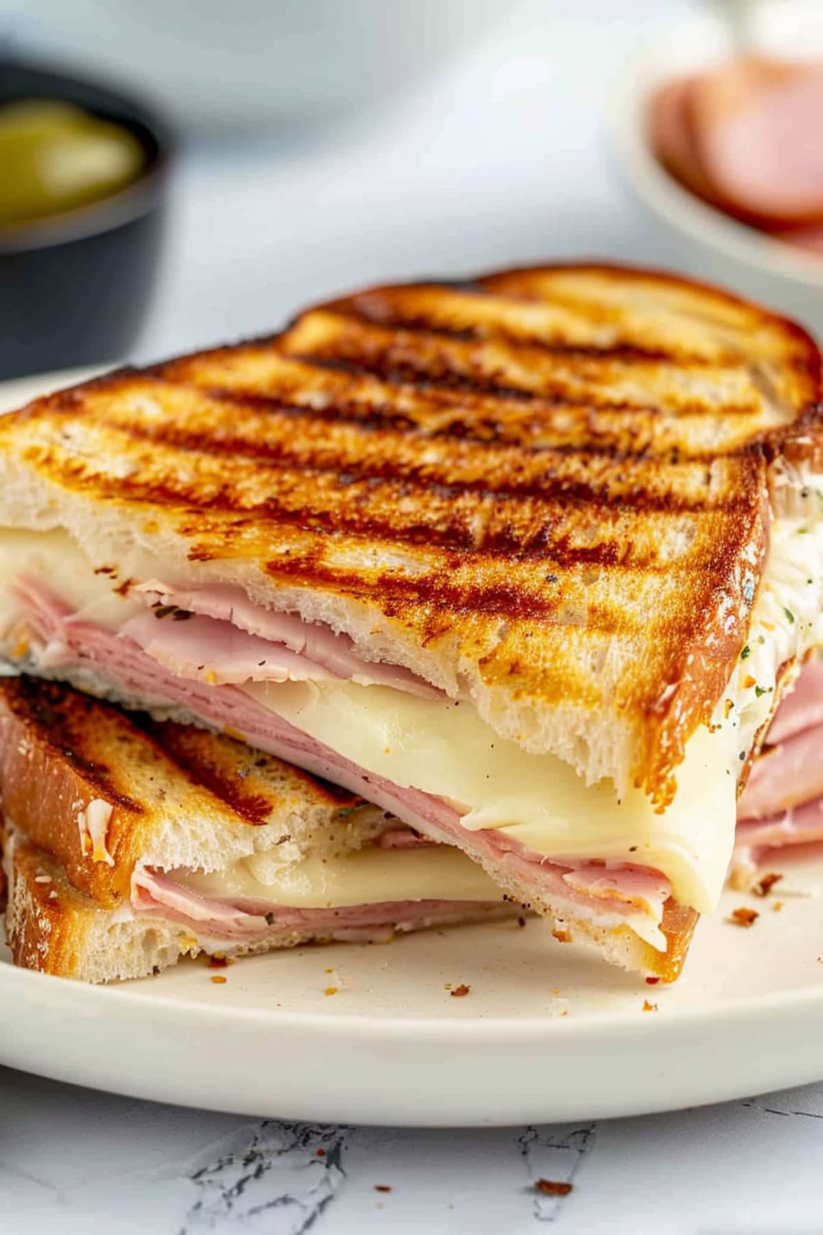 Sandwich with a combination of melted Swiss cheese, savory ham, and tangy mustard-butter spread.