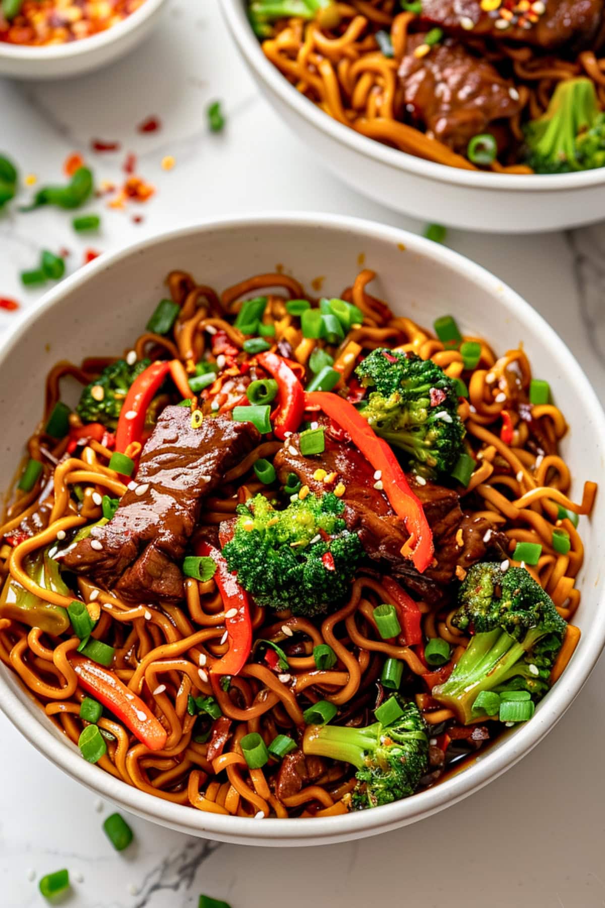 Two bowls serving of sticky beef noodles.