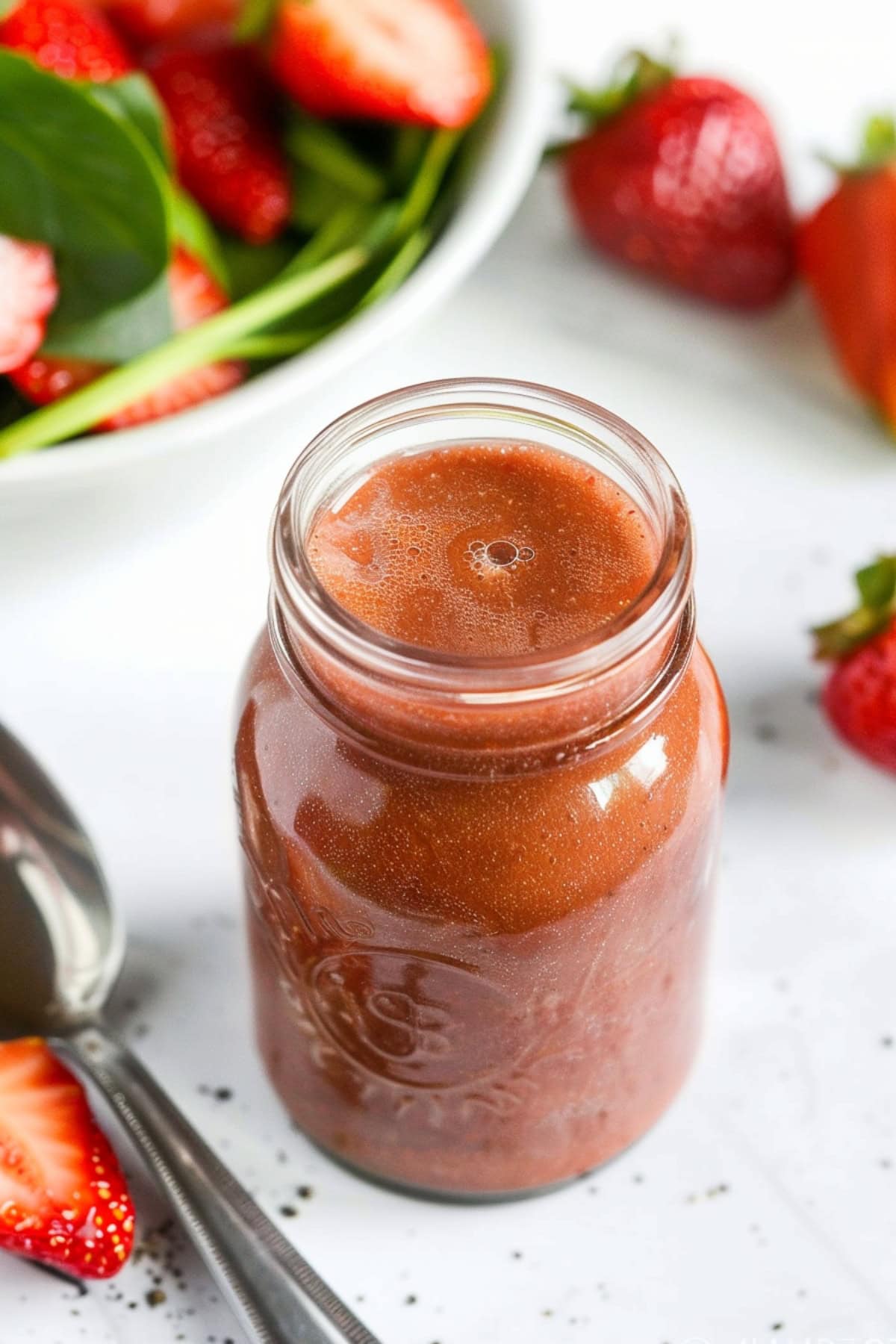 Strawberry balsamic dressing in a small jar. 