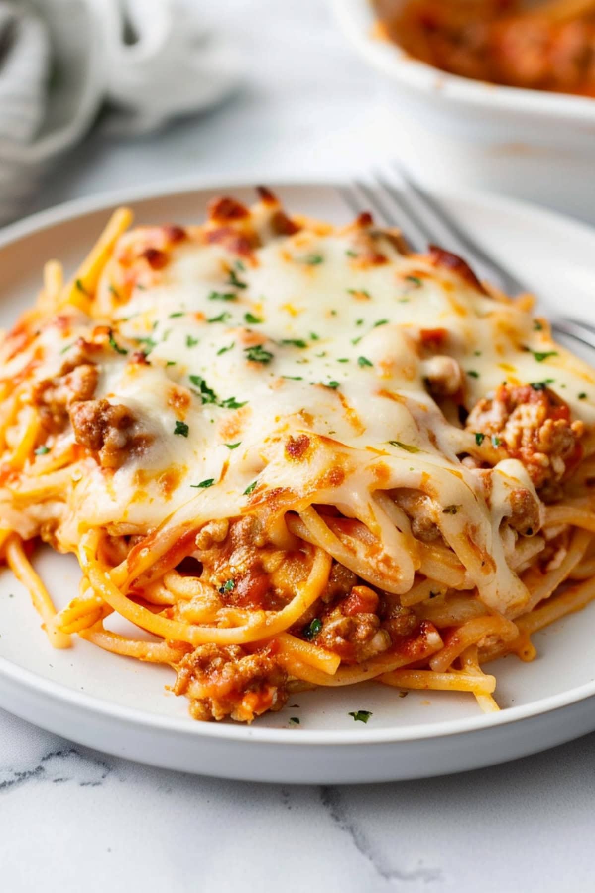 Tiktok spaghetti with ground beef in a white plate, close-up