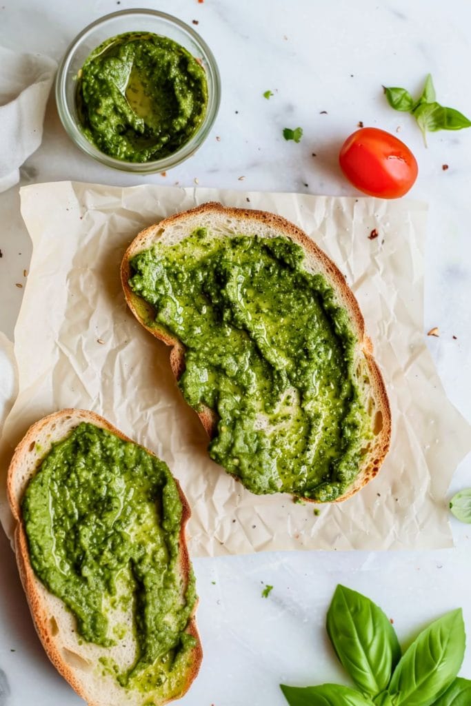 Sourdough bread with pesto spread on top.