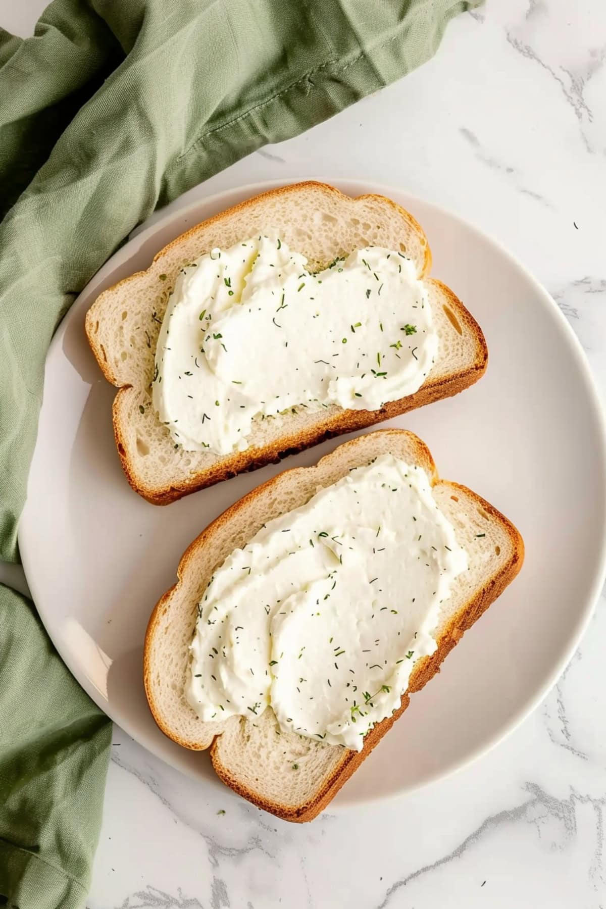 Top View of Herbed Cream Cheese with Toasted Breads in a White Plate.