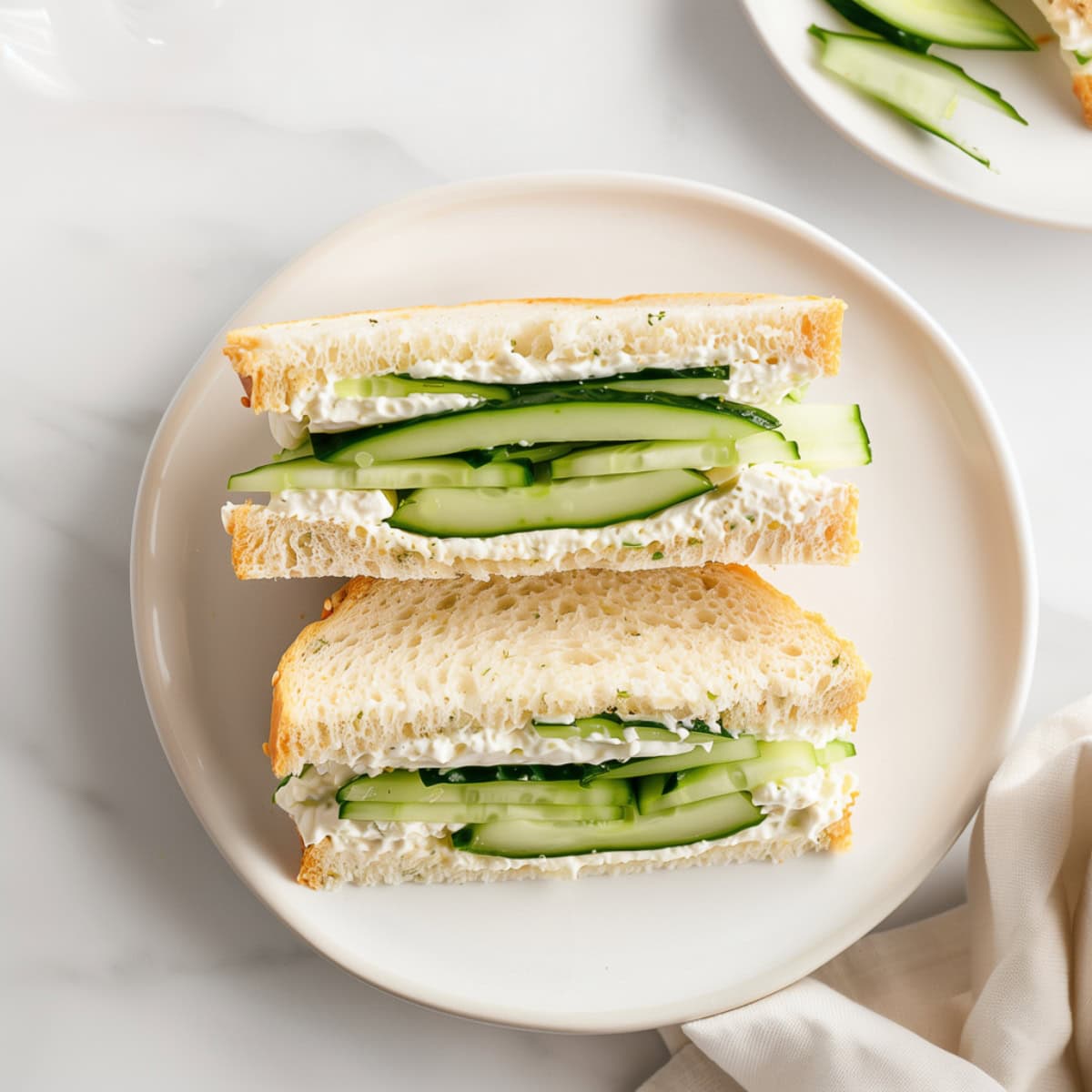 Fresh cucumber sandwiches with creamy dill spread on whole wheat bread.