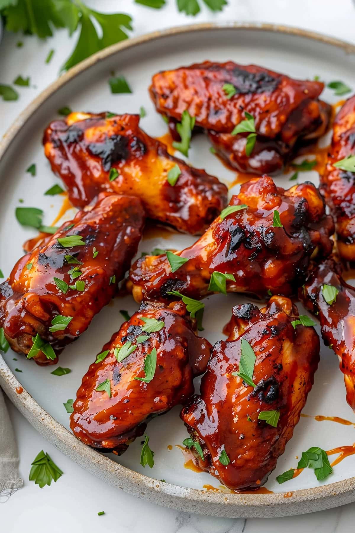 BBQ Chicken Wings in a Plate Garnished with Parsley.